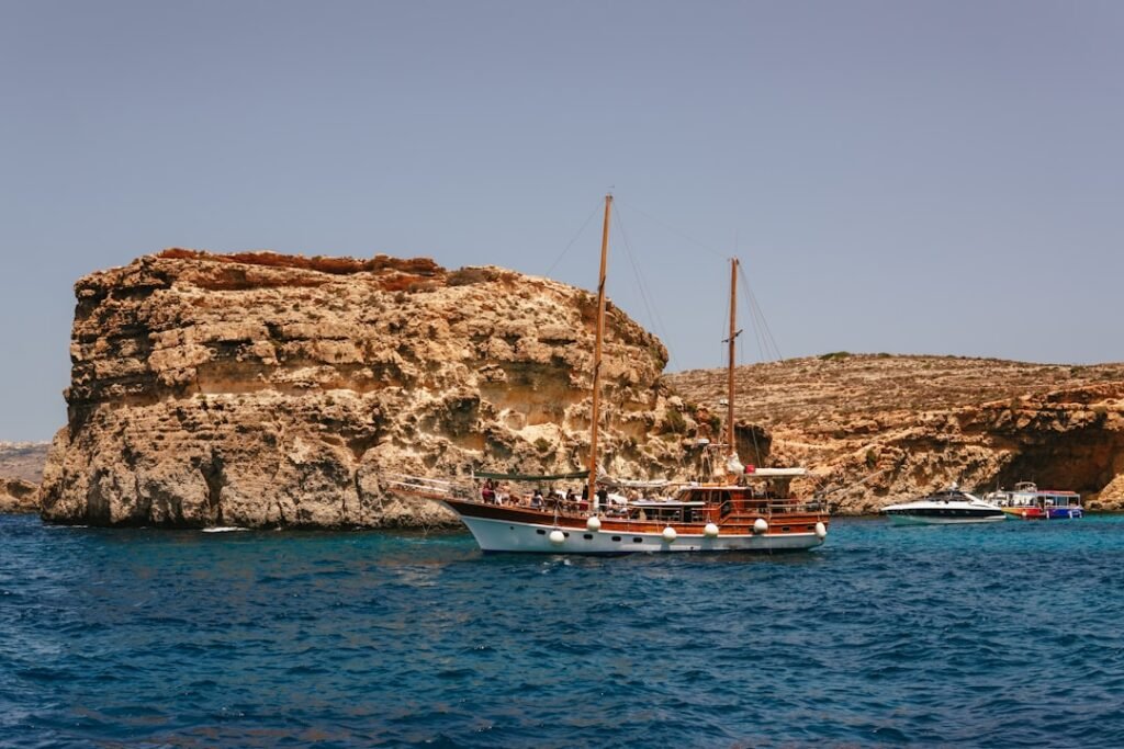 A boat in the water near a rocky island