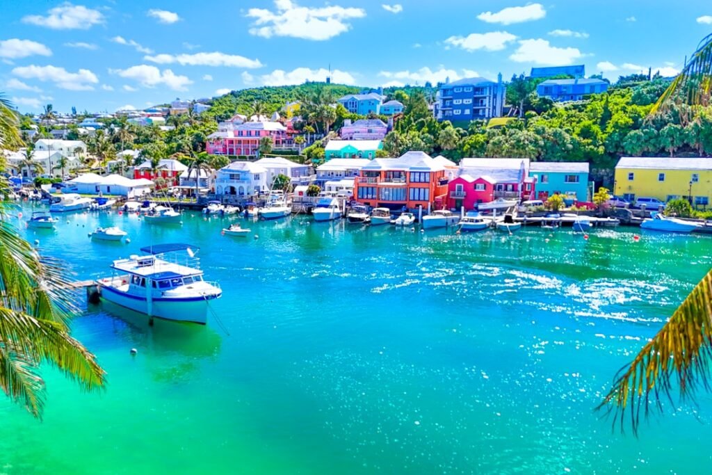 Boats and colorful buildings surround the turquoise water.