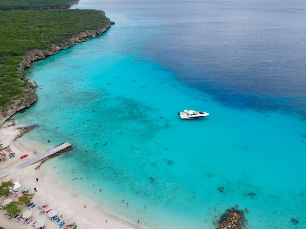 white boat on blue sea water during daytime